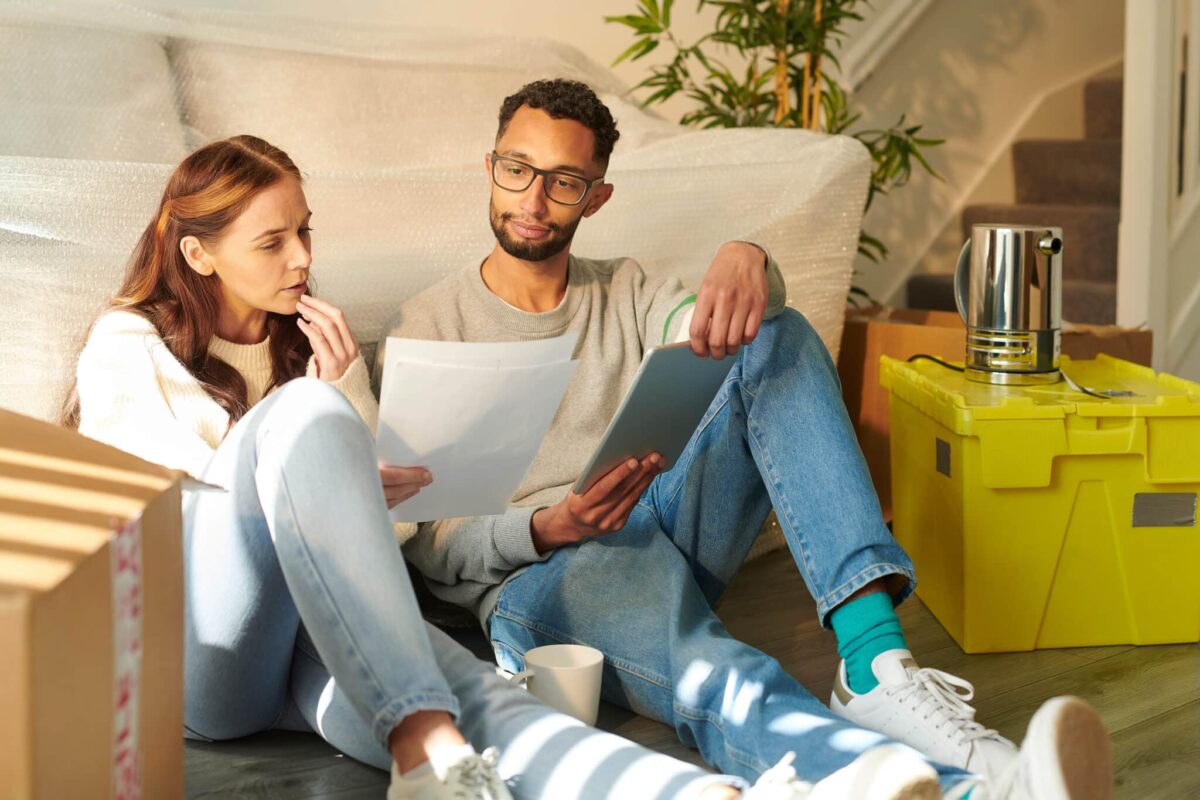 couple sitting calculating their moving budget