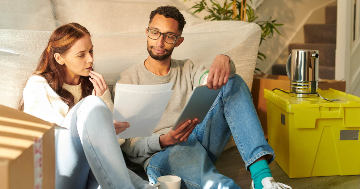 couple sitting calculating their moving budget